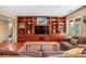 Cozy living room featuring custom built-in shelving and drawers with ample space for storage at 12653 Rancho Ct, Conifer, CO 80433