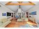 Spacious open floor plan with hardwood floors, wooden beams, and large windows for natural light and views at 12653 Rancho Ct, Conifer, CO 80433