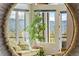 Living room with mountain view through windows, comfortable sofa, and potted plant at 12653 Rancho Ct, Conifer, CO 80433