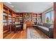 Well appointed office space with custom built-in wooden bookshelves and a view from the window at 12653 Rancho Ct, Conifer, CO 80433