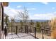 Open deck with railing shows off the wooded views in a natural setting at 12653 Rancho Ct, Conifer, CO 80433