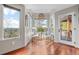 Bright sitting room with views, featuring hardwood floors and comfortable seating near large windows at 12653 Rancho Ct, Conifer, CO 80433