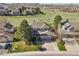 Aerial shot of the home's exterior featuring the garage, driveway, and well-maintained landscaping at 9977 Falcon Creek Dr, Highlands Ranch, CO 80130