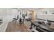 Basement with a home gym including weight machines, weights, mirror and treadmill at 9977 Falcon Creek Dr, Highlands Ranch, CO 80130