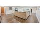 Finished basement area featuring a large sofa and wood-look floors at 9977 Falcon Creek Dr, Highlands Ranch, CO 80130