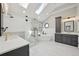 Spacious bathroom with dual vanities, walk-in shower, and free-standing tub at 9977 Falcon Creek Dr, Highlands Ranch, CO 80130