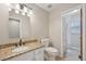 Cozy bathroom featuring tiled floor, granite countertop and shower with curtain at 9977 Falcon Creek Dr, Highlands Ranch, CO 80130