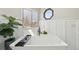 Soaking tub with modern black fixtures and white wainscotting detail at 9977 Falcon Creek Dr, Highlands Ranch, CO 80130