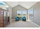 Comfortable sitting area with vaulted ceiling and scenic view from the bedroom at 9977 Falcon Creek Dr, Highlands Ranch, CO 80130