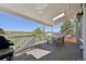 Inviting covered deck with a skylight, featuring a rustic dining set and lush views at 9977 Falcon Creek Dr, Highlands Ranch, CO 80130