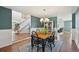 Dining room featuring hardwood floors, a stylish chandelier, and modern accents at 9977 Falcon Creek Dr, Highlands Ranch, CO 80130