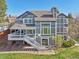Aerial view of a large two-story home with a well-manicured lawn and back deck at 9977 Falcon Creek Dr, Highlands Ranch, CO 80130