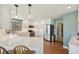Well-lit kitchen featuring white cabinets, stainless steel appliances and hardwood floors at 9977 Falcon Creek Dr, Highlands Ranch, CO 80130