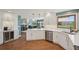 Bright kitchen featuring white cabinets, stainless steel appliances, hardwood floors, and an island at 9977 Falcon Creek Dr, Highlands Ranch, CO 80130
