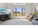Bright living room with large windows overlooking green fields and featuring a comfortable seating area at 9977 Falcon Creek Dr, Highlands Ranch, CO 80130