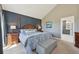 Main bedroom with paneling, connecting door to bathroom, and neutral decor at 9977 Falcon Creek Dr, Highlands Ranch, CO 80130