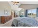 Vaulted bedroom showing sitting area, TV, large dresser, and exterior views at 9977 Falcon Creek Dr, Highlands Ranch, CO 80130