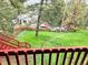 View of the backyard from the deck, showing the grassy lawn and fence at 29983 Hilltop Dr # 2, Evergreen, CO 80439