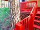 View of the deck steps surrounded by trees and grass at 29983 Hilltop Dr # 2, Evergreen, CO 80439
