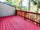 Outdoor deck with red-stained wood overlooking mature trees that offers a private and peaceful outdoor living space at 29983 Hilltop Dr # 2, Evergreen, CO 80439