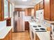 Functional kitchen with stainless steel refrigerator, white countertops, and classic wood cabinetry at 29983 Hilltop Dr # 2, Evergreen, CO 80439