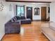 Bright living room featuring hardwood floors, a comfortable gray sectional sofa, and ample natural light at 29983 Hilltop Dr # 2, Evergreen, CO 80439
