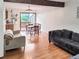 Open-concept living and dining area with hardwood floors, comfortable seating, and access to a balcony at 29983 Hilltop Dr # 2, Evergreen, CO 80439