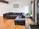 Cozy living room with a plush gray sectional sofa, complemented by wood floors and bright natural light at 29983 Hilltop Dr # 2, Evergreen, CO 80439