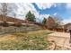 Beautiful backyard showcasing tiered landscaping and mature trees, creating a serene outdoor retreat at 468 English Sparrow Trl, Highlands Ranch, CO 80129