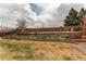 Spacious backyard with tiered landscaping and a wooden fence, offering privacy and natural beauty at 468 English Sparrow Trl, Highlands Ranch, CO 80129