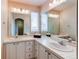 A bathroom with double sinks, white tile countertops, and a large mirror at 468 English Sparrow Trl, Highlands Ranch, CO 80129