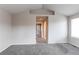 An empty bedroom with neutral walls, carpet, and a doorway leading to other rooms at 468 English Sparrow Trl, Highlands Ranch, CO 80129