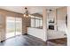 A dining area featuring dark wood floors, sliding glass doors, and a decorative chandelier at 468 English Sparrow Trl, Highlands Ranch, CO 80129
