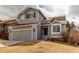 Charming two-story home featuring a well-manicured lawn, attached garage, and classic architectural details at 468 English Sparrow Trl, Highlands Ranch, CO 80129