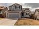 Charming two-story home with a gray exterior, attached garage, and well-maintained lawn at 468 English Sparrow Trl, Highlands Ranch, CO 80129