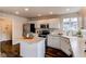 A well-lit kitchen with white cabinets, stainless steel appliances, and a kitchen island at 468 English Sparrow Trl, Highlands Ranch, CO 80129