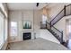 Bright living room with a fireplace, staircase, and large windows for ample natural light at 468 English Sparrow Trl, Highlands Ranch, CO 80129