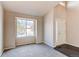 Bright living room with large window, neutral carpet, and a view of the front yard at 468 English Sparrow Trl, Highlands Ranch, CO 80129