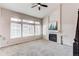 Inviting living room featuring a fireplace, large windows, and a ceiling fan at 468 English Sparrow Trl, Highlands Ranch, CO 80129