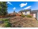 Large backyard with mature trees, fence, and a wooden deck at 5031 Upton Ct, Denver, CO 80239