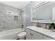 Modern bathroom with marble tile and updated vanity at 5031 Upton Ct, Denver, CO 80239