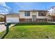Charming two-story home features a well-manicured front lawn and classic curb appeal at 5031 Upton Ct, Denver, CO 80239