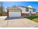 Two-car garage with driveway and attractive exterior at 5031 Upton Ct, Denver, CO 80239