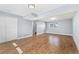 Large living room with sliding door closet and vinyl floors at 5031 Upton Ct, Denver, CO 80239