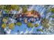 Bird's-eye view of house nestled in a snowy wooded area at 590 Cumberland Rd, Larkspur, CO 80118