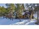 House with a large yard and snow covered ground at 590 Cumberland Rd, Larkspur, CO 80118