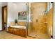 Bathroom featuring a soaking tub and walk-in shower at 590 Cumberland Rd, Larkspur, CO 80118