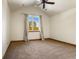 Bright bedroom with carpeted floor and ceiling fan at 590 Cumberland Rd, Larkspur, CO 80118