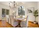 Elegant dining room featuring a large wood table, chandelier, and hardwood floors at 590 Cumberland Rd, Larkspur, CO 80118