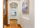 Bright hallway with hardwood floors and decorative niche at 590 Cumberland Rd, Larkspur, CO 80118